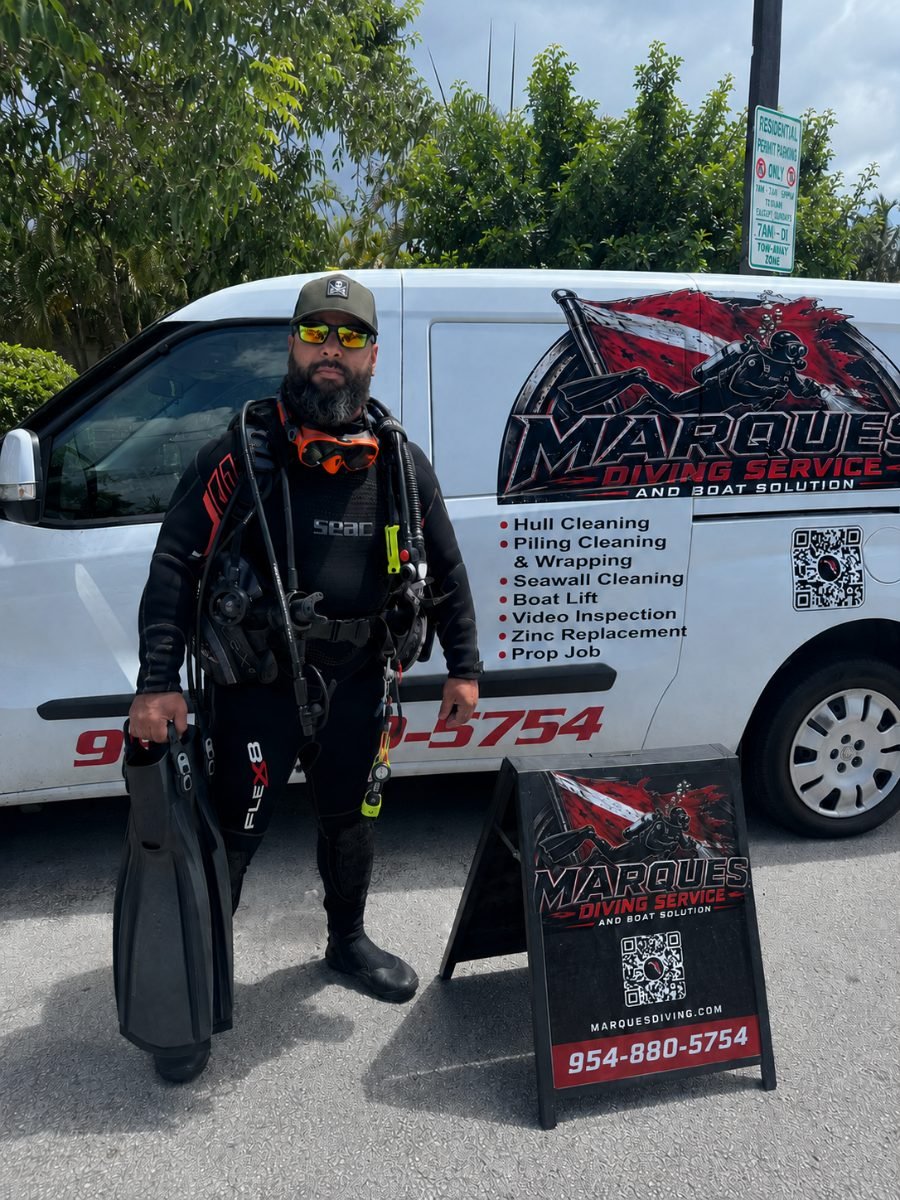 Danilo Marques, owner and lead commercial diver at Marques Diving Service, in full scuba gear beside the company van in Fort Lauderdale, FL